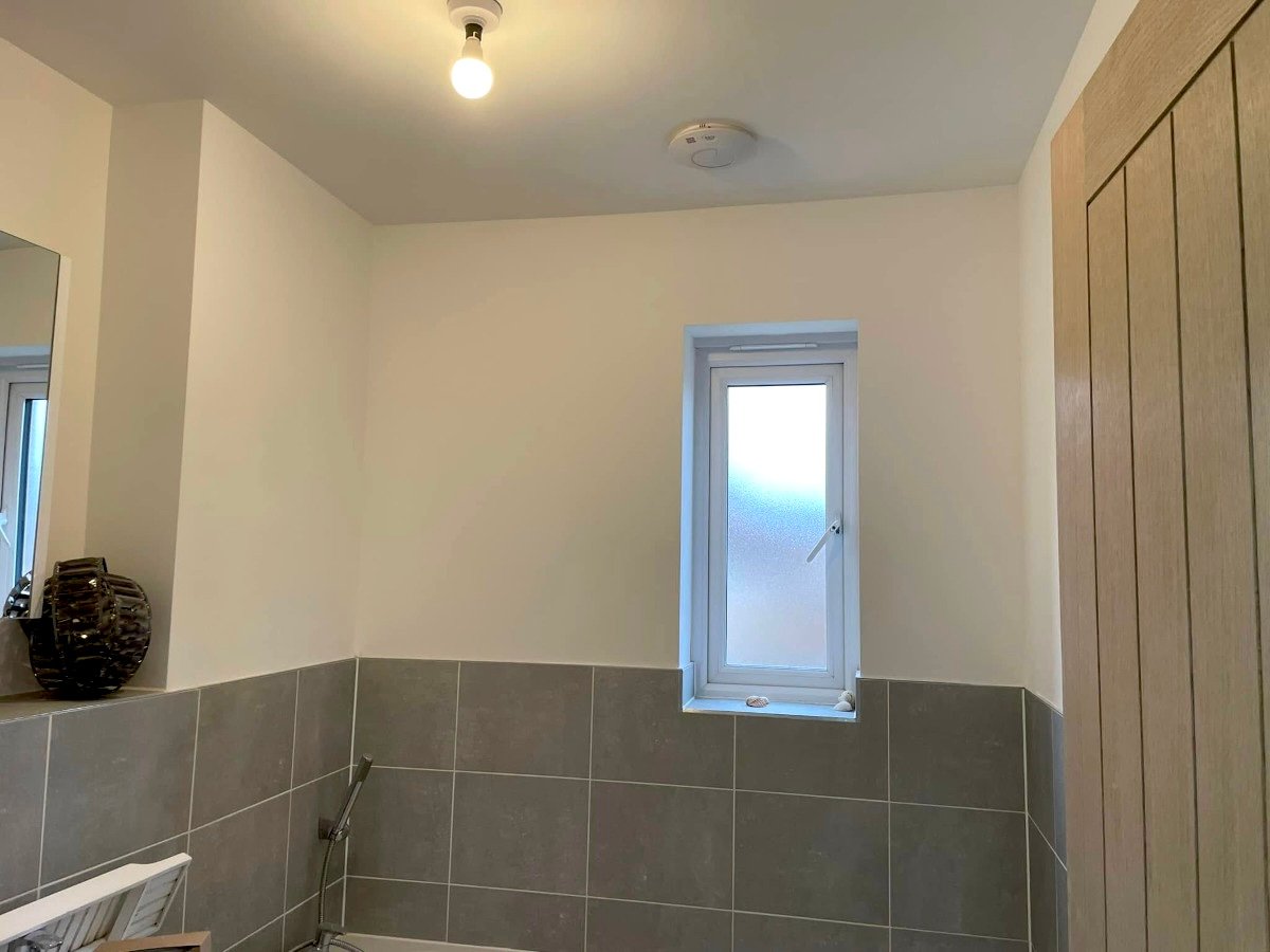 Bathroom painting in Newport by Orchid Decor, cream painted ceiling with grey tiles