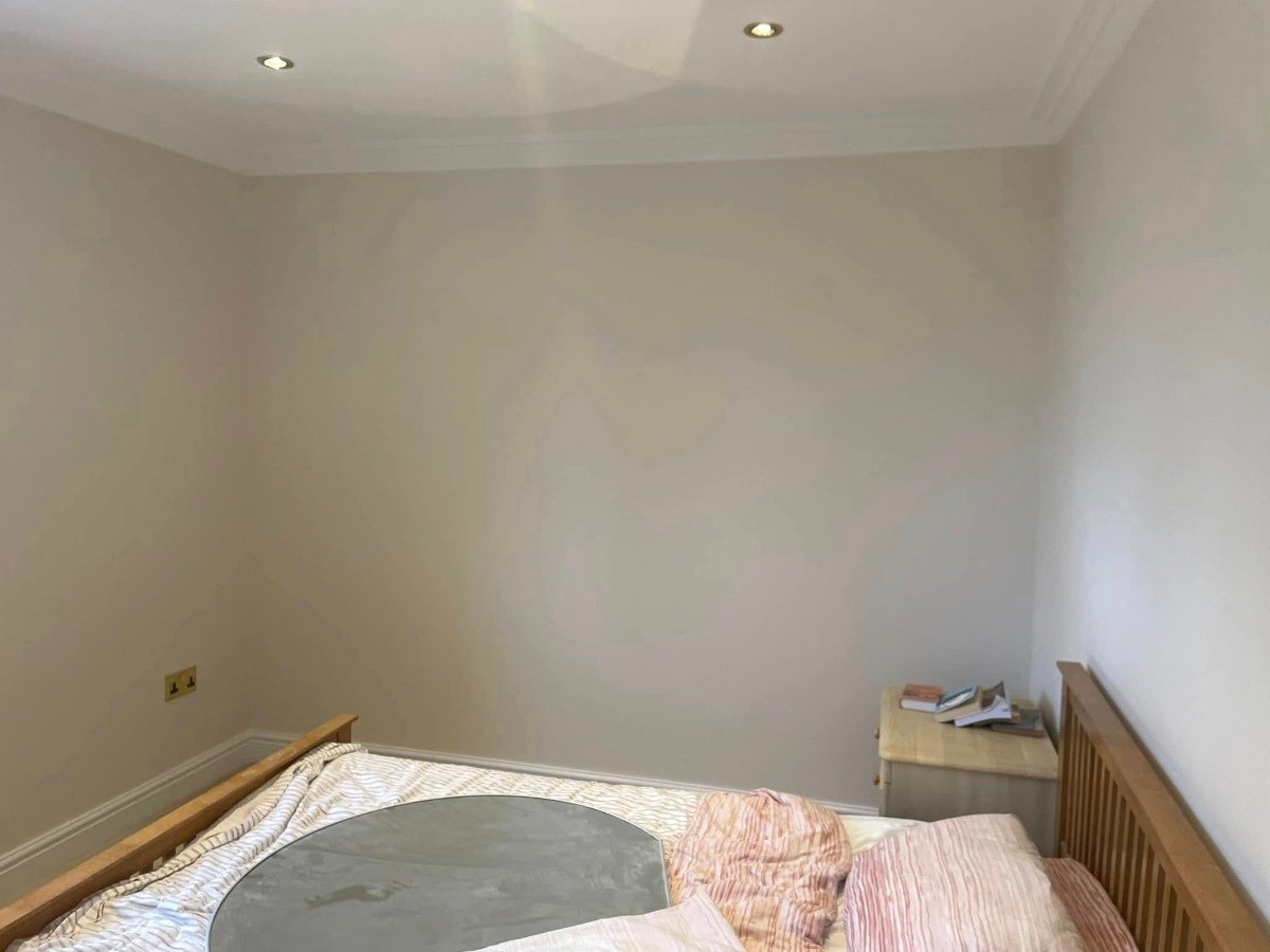 Bedroom with grey painted walls and double bed in Newport by Orchid Decor