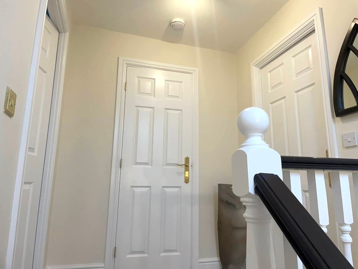 White painted ceiling with pendant light and staircase in Newport property