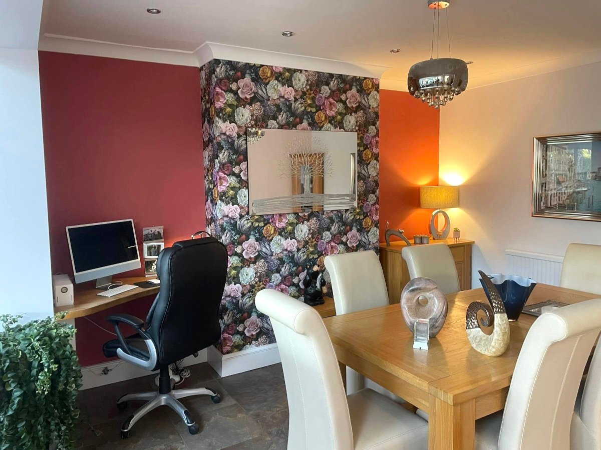dining-room-burgundy-wallpaper-orange-painted-walls-newport-orchid-decor Dining room in Newport home with a floral feature wall by Orchid Decor, expert wallpaper fitters in Newport.
