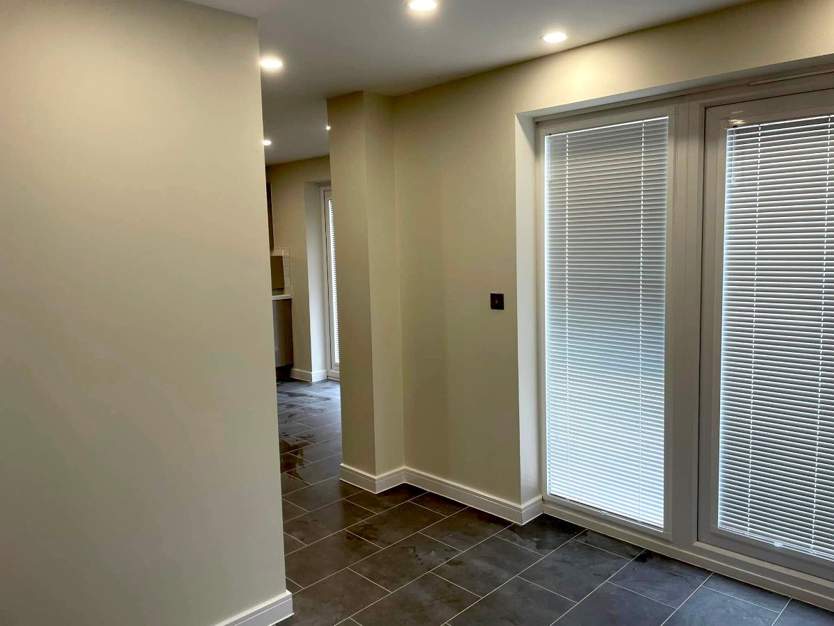 Extension with cream painted walls and bifold doors after renovation painting in Newport