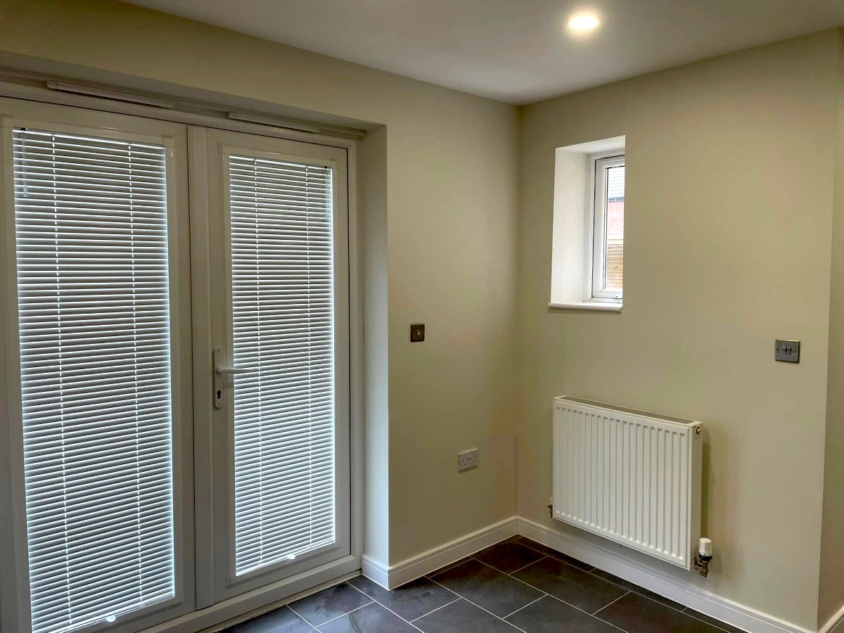 Home renovation painting in Newport by Orchid Decor, freshly painted extension with patio doors