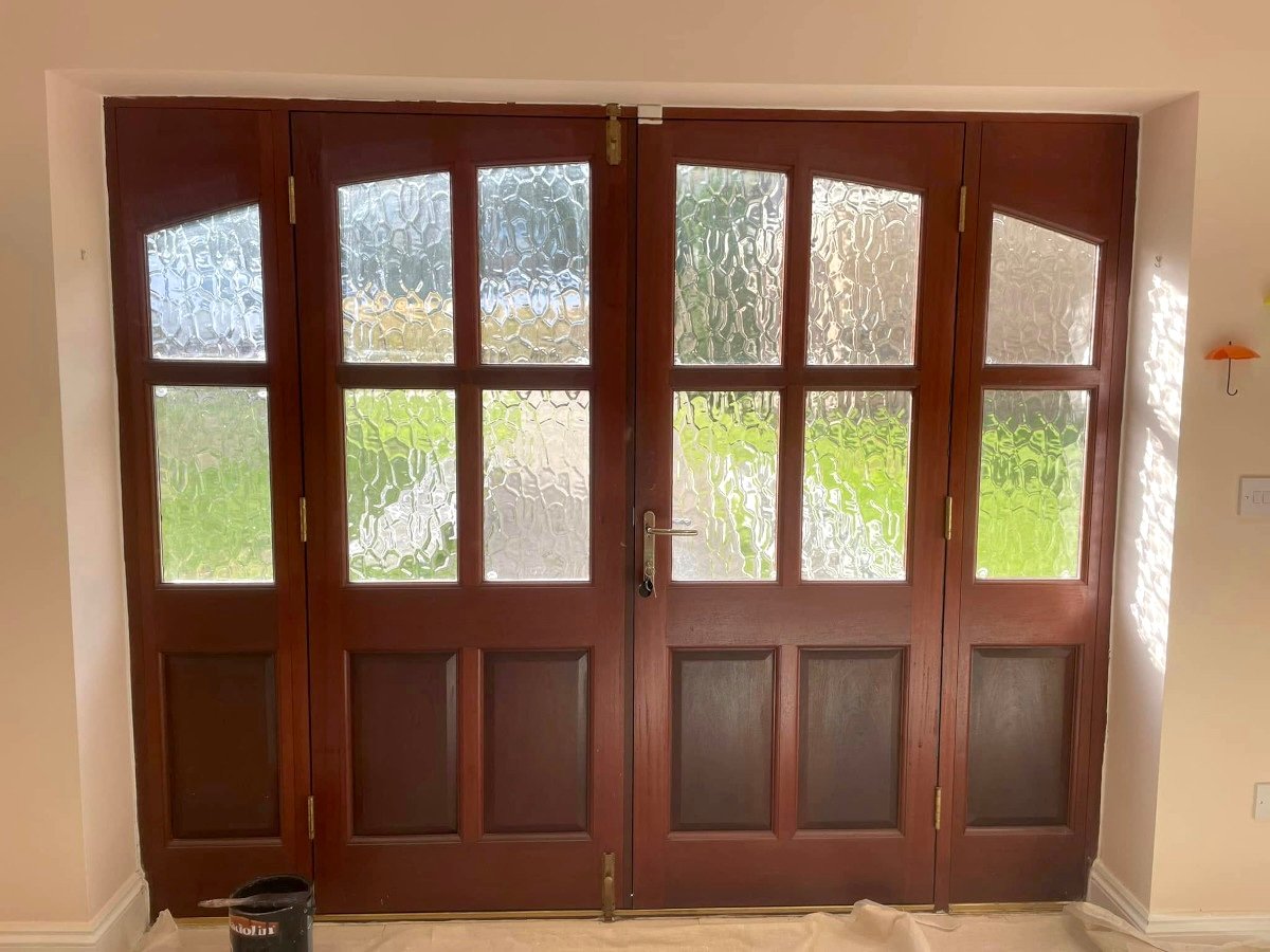 Hallway with cream painted walls and mahogany French doors in Newport