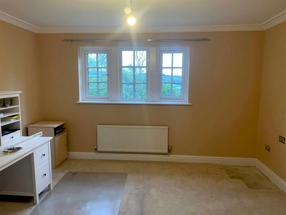 Home office with beige painted walls and large windows in Newport by Orchid Decor