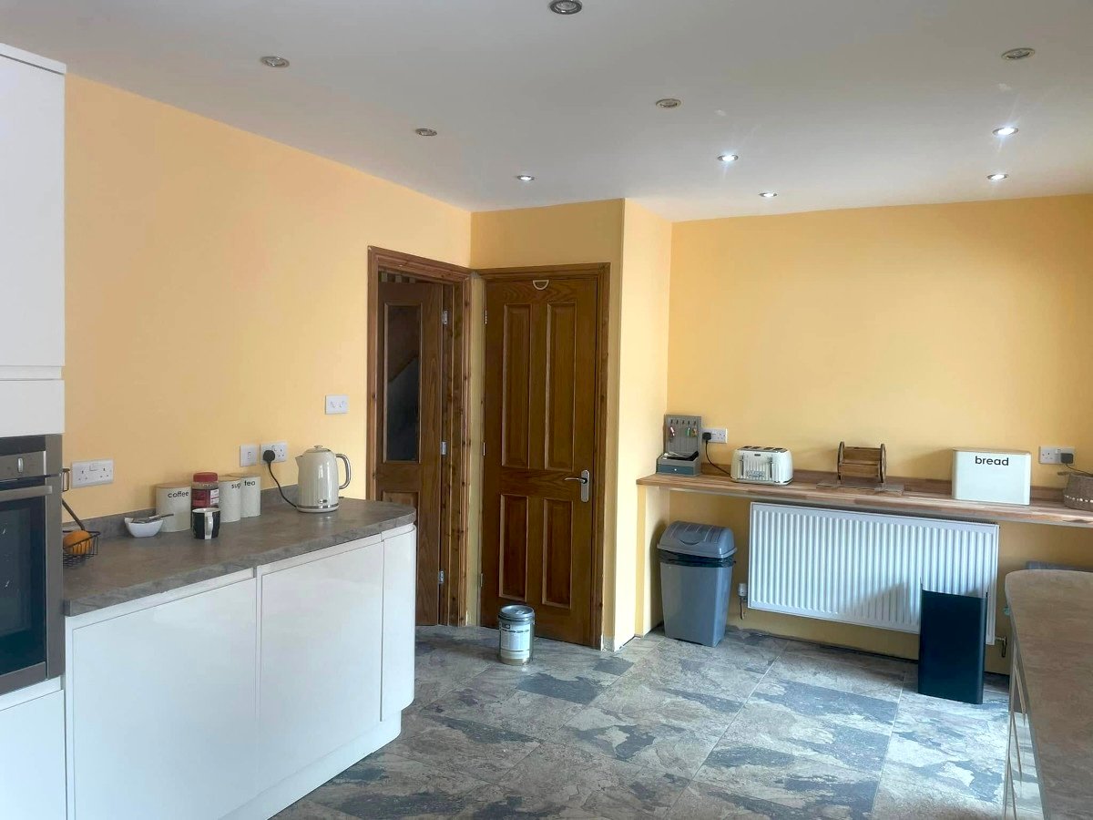 kitchen yellow painted walls breakfast bar tiled floor newport orchid decor