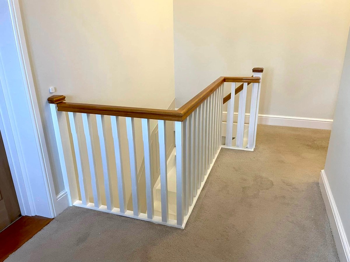 Period staircase with cream painted walls and white banister in Newport