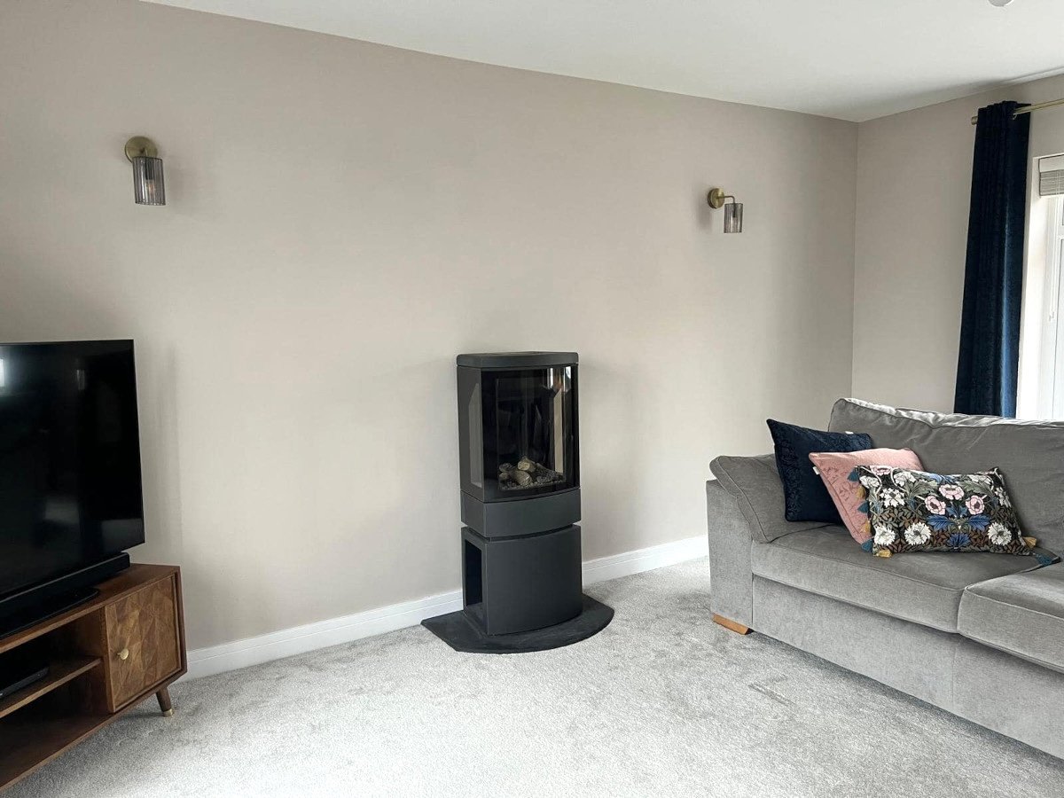 Living room with beige painted walls and modern stove, interior painting in Caldicot by Orchid Decor