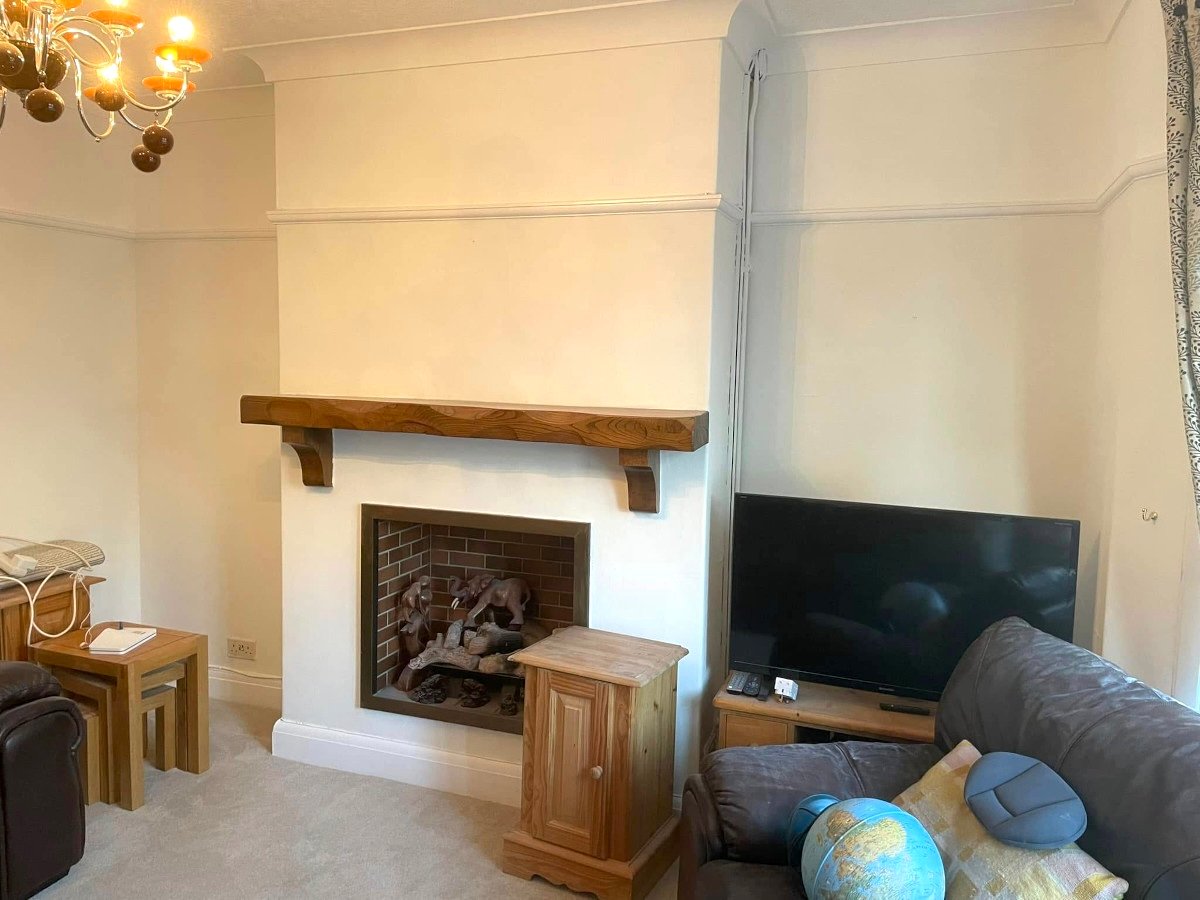 living-room-cream-painted-walls-brick-fireplace-newport-orchid-decor Living room wall painting in Newport by Orchid Decor, cream painted walls with brick fireplace