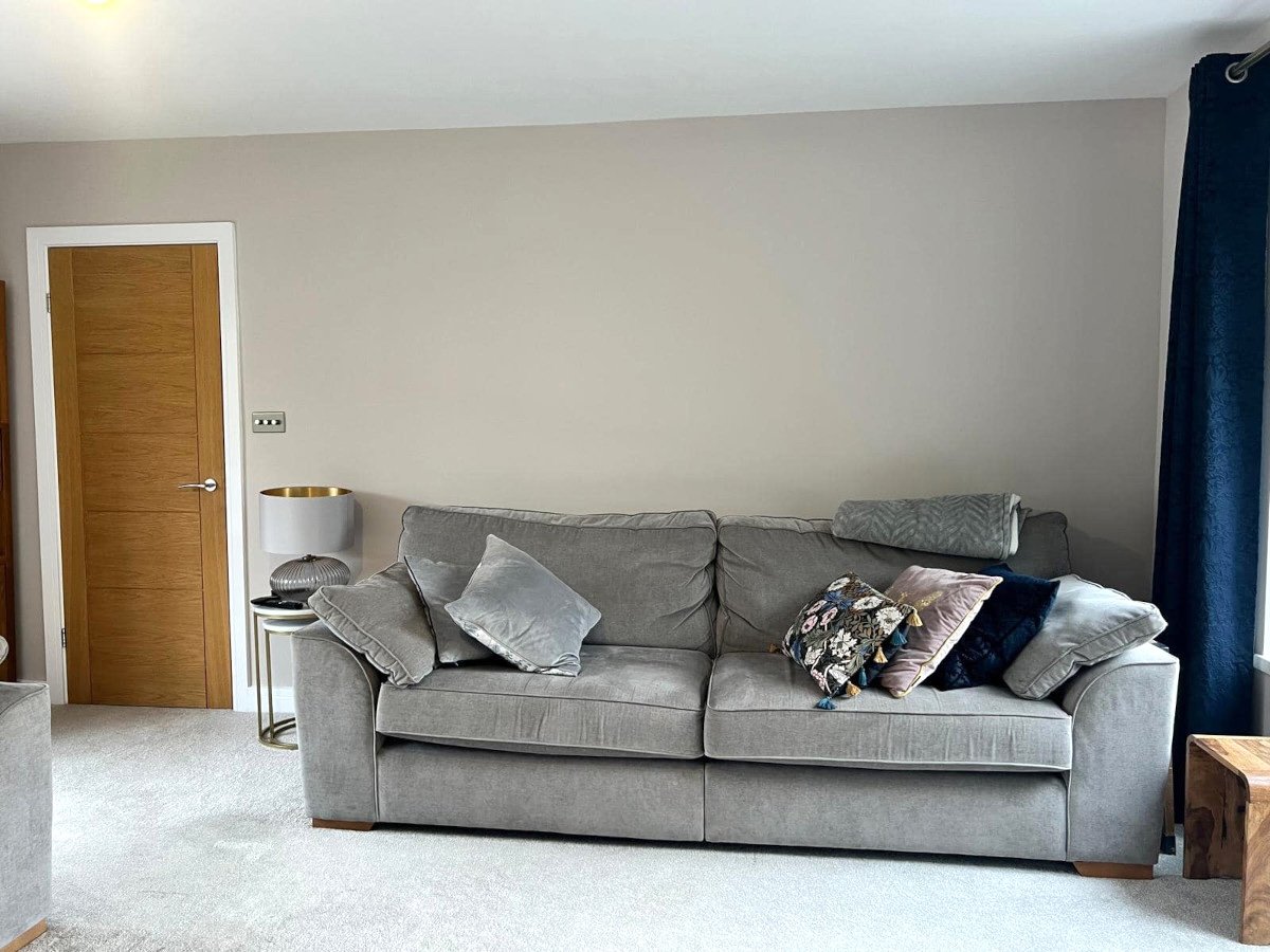 Interior painting in Newport by Orchid Decor, grey painted living room walls with sofa and oak door
