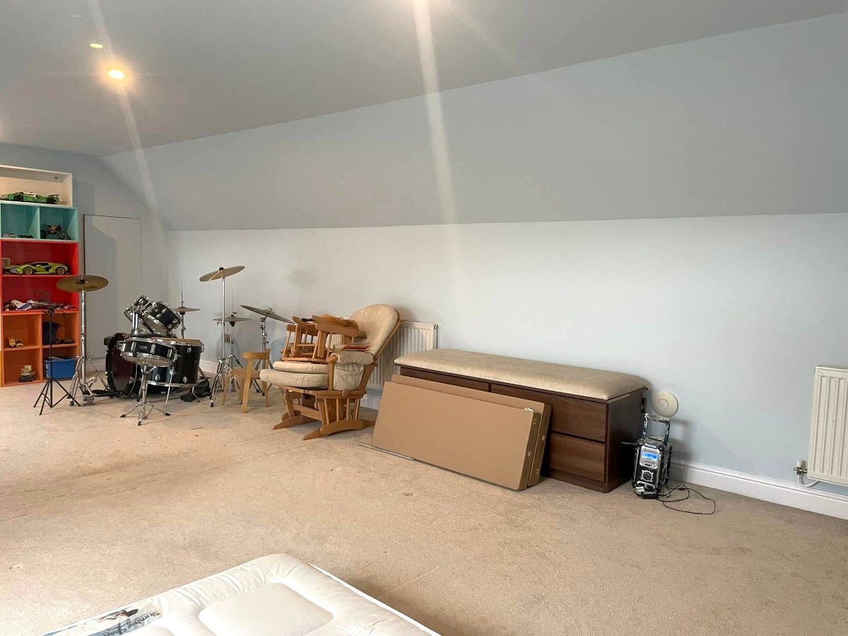 Loft room with blue painted feature walls and ceiling in Newport