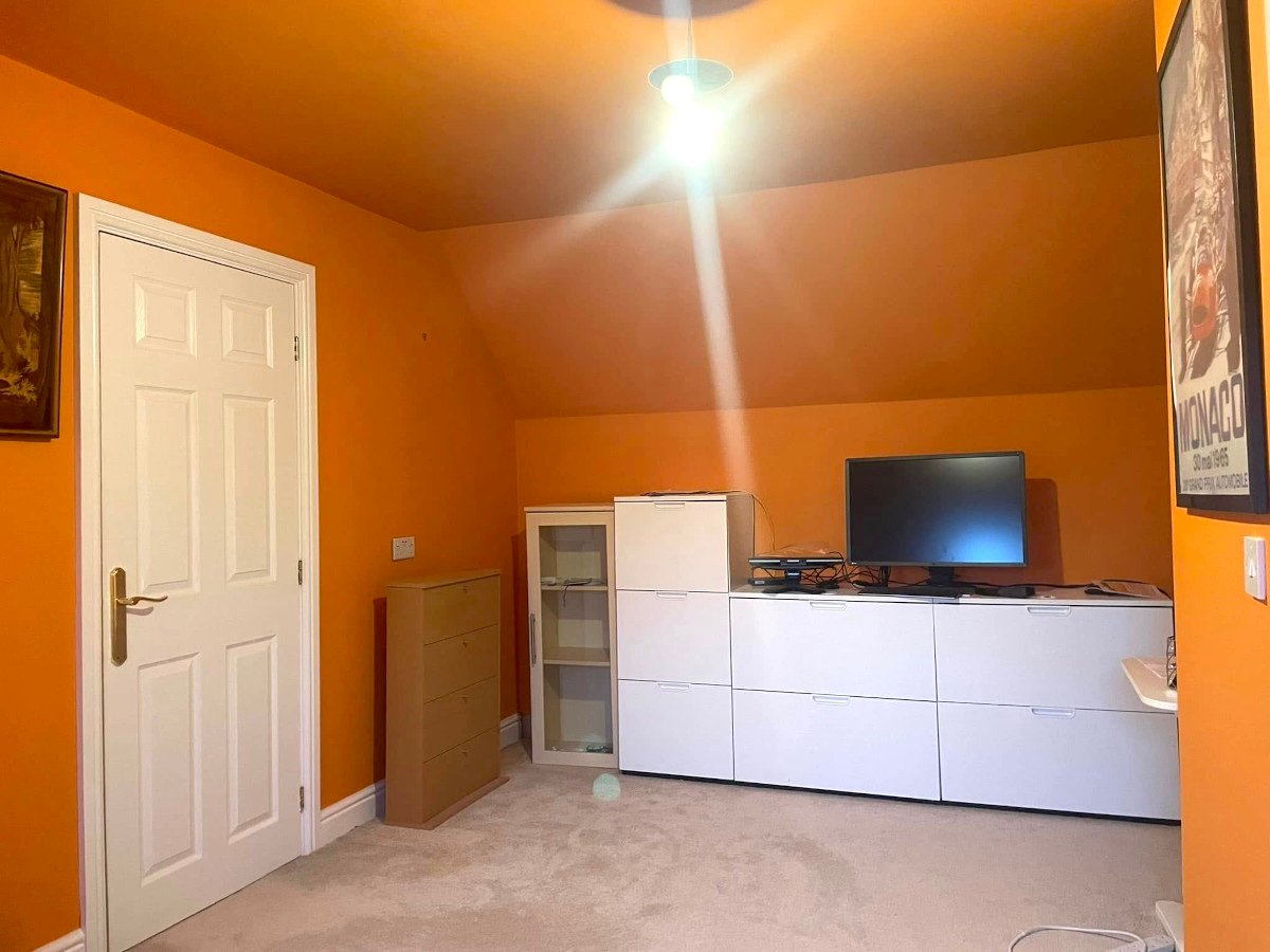 Loft room with orange painted walls and ceiling in Newport by Orchid Decor