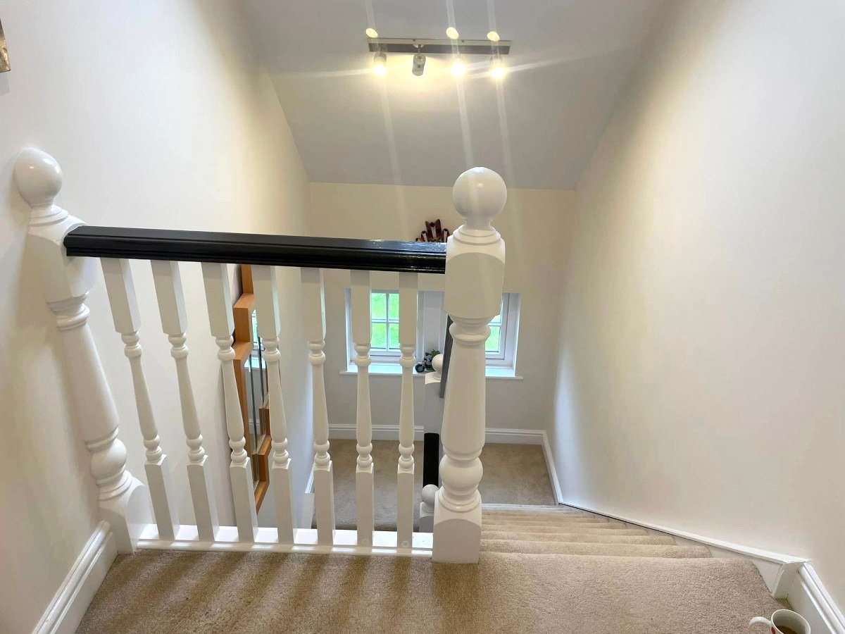 staircase cream painted walls white banister newport orchid decor