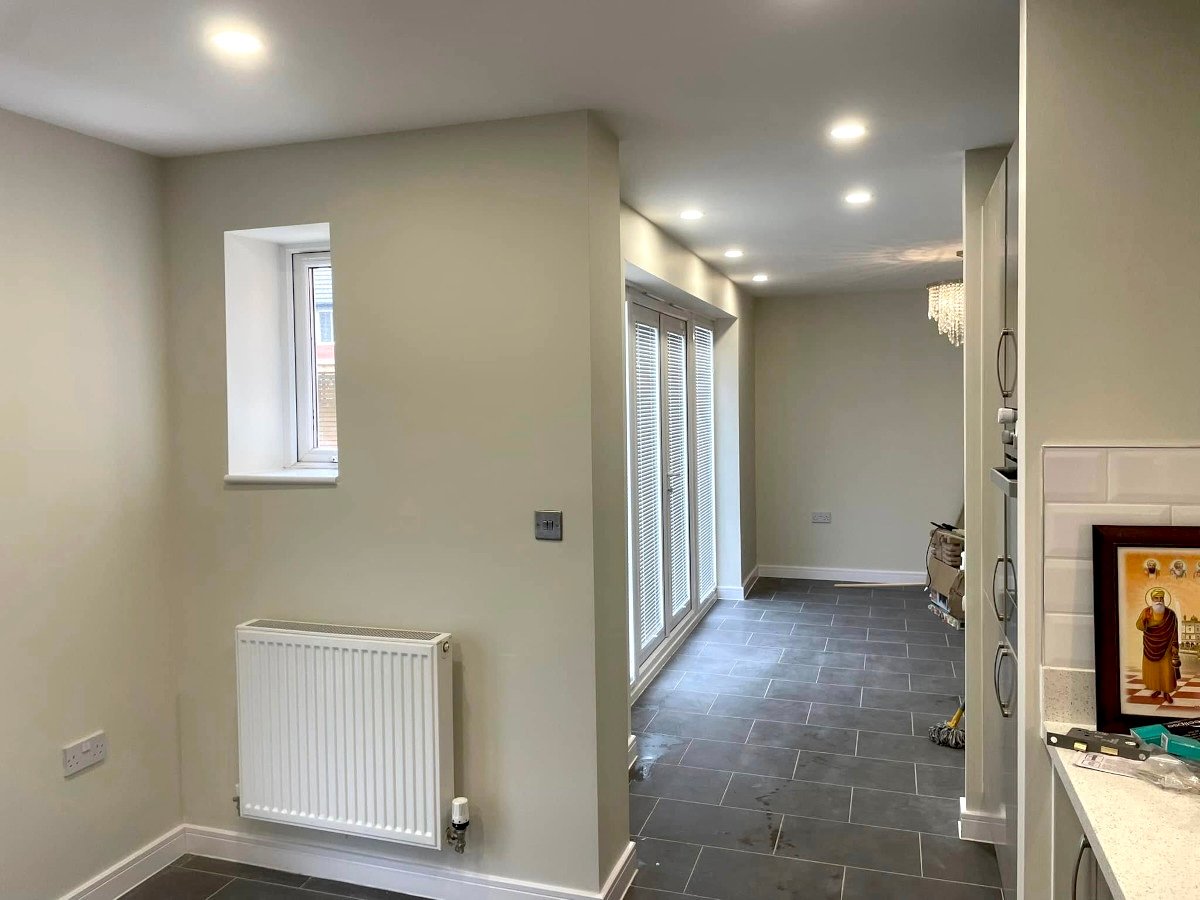 Utility room with cream painted walls and grey tiled floor in Newport by Orchid Decor
